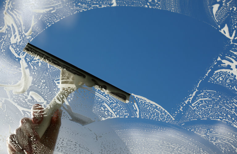 person washing car's windshield