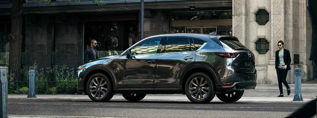 2019 mazda CX-5 Signature facing left parked by city with person walking around back