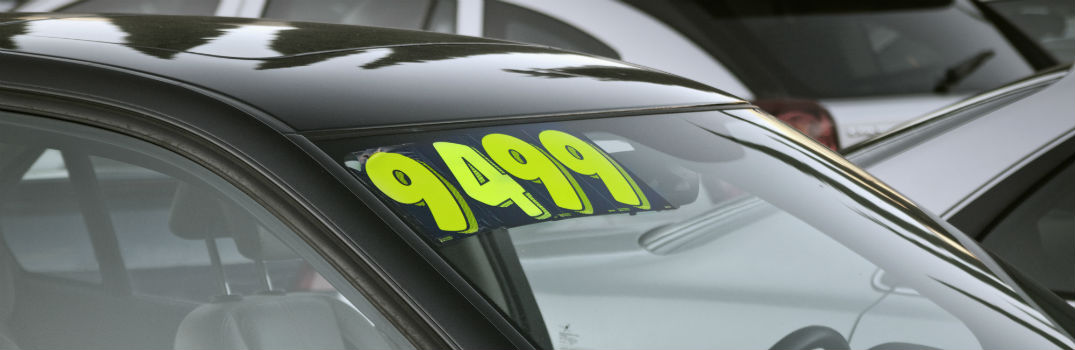 used car with price sticker on windshield