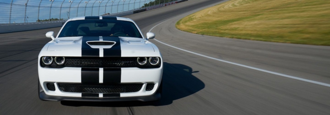 White 2018 Dodge Challenger driving on race track