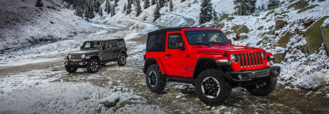 Two 2018 Jeep Wrangler models parked off-road