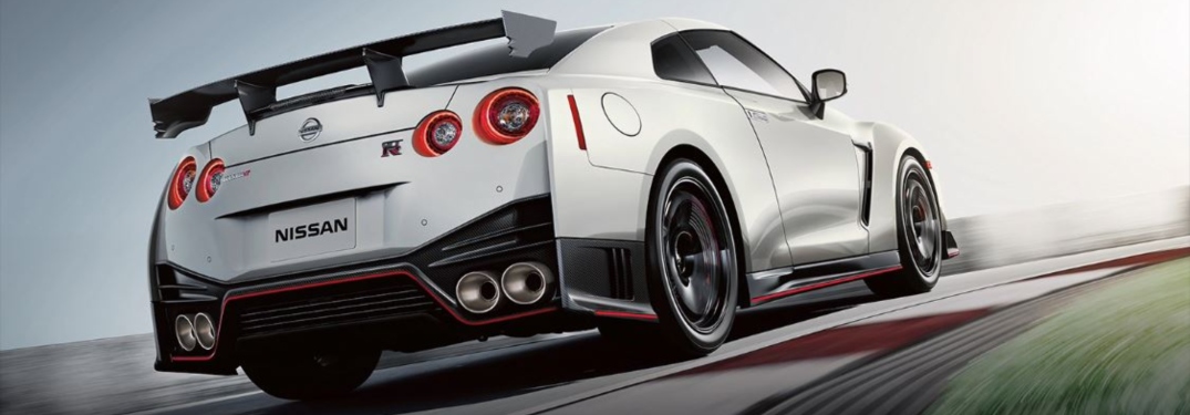 Rear view of a white Nissan NISMO vehicle on the track
