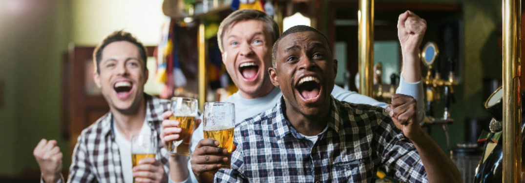 people watching basketball in a bar