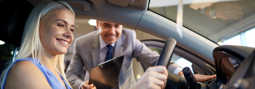 prospective car buyer sitting in driver's seat
