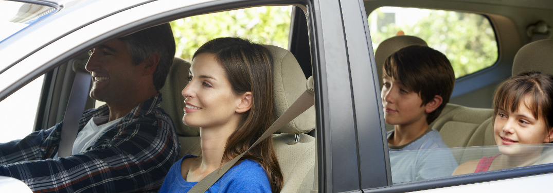 family of four riding in a sedan