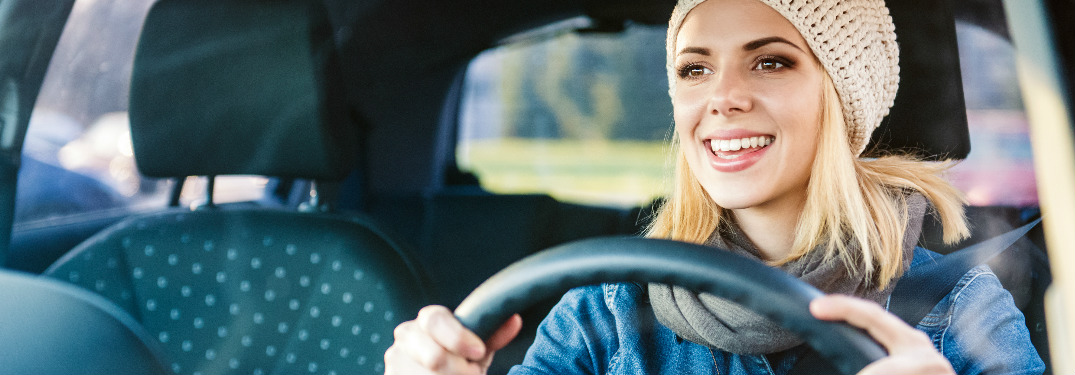 Woman in a hat driving a car