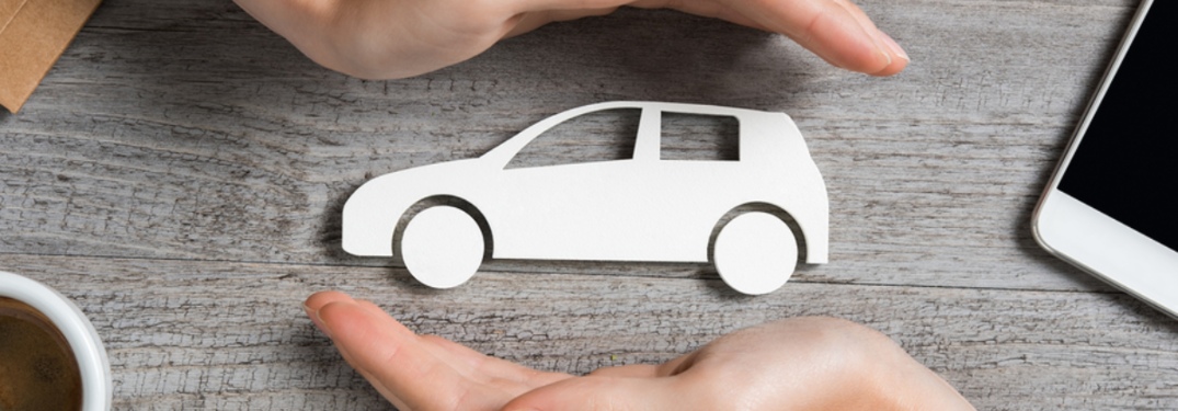Hands protecting little car