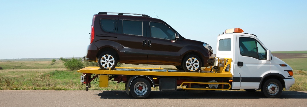 Flatbed with vehicle on the back