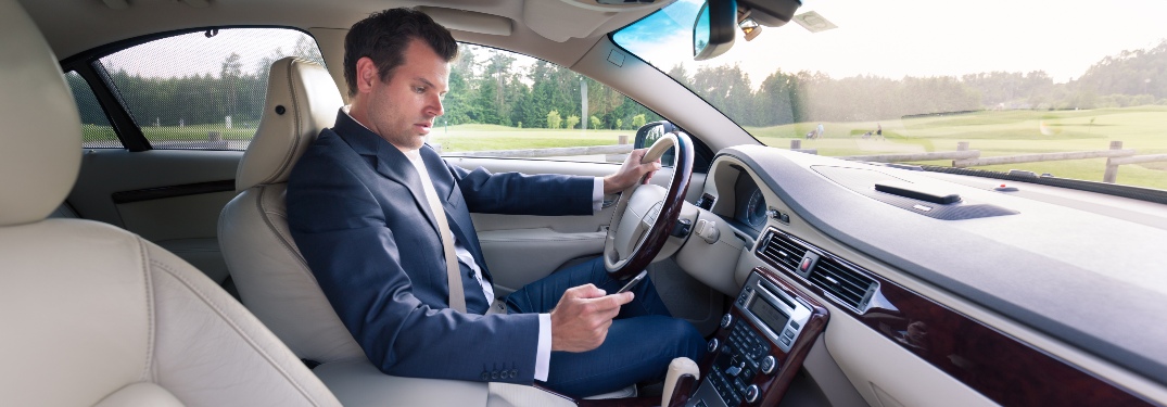 Man texting while driving on his way to work