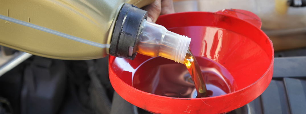 Oil Being Poured Down Red Funnel