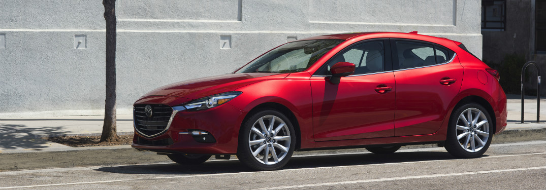 red 2018 mazda3 parked on city street