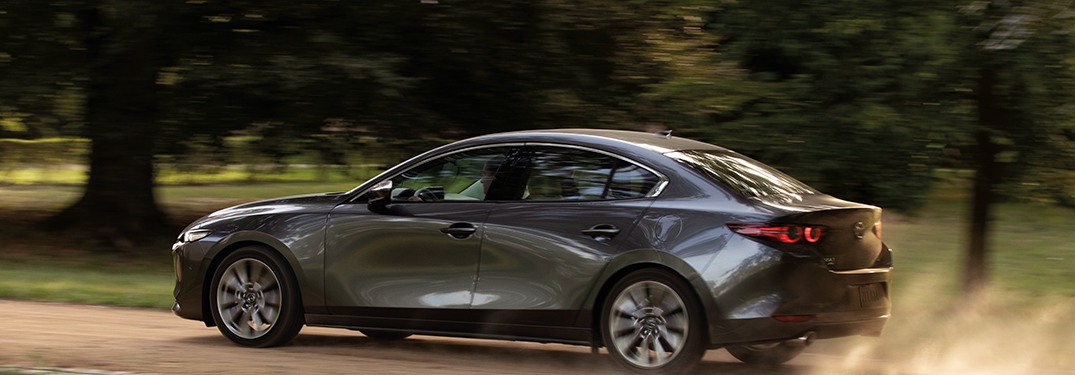 2020 Mazda3 Sedan driving down a trail