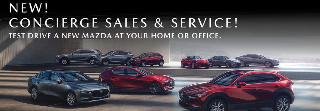 A showcase of Mazda vehicles ina darkened room with an overlayed text that says "New! Concierge Sales and Service! Test drive a new Mazda at your home or office."