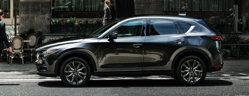 A side image of a 2020 Mazda CX-5 parked along a city street.