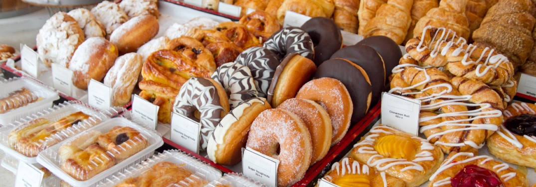 An image of baked goods, such as donuts and turnovers, at a bakery.