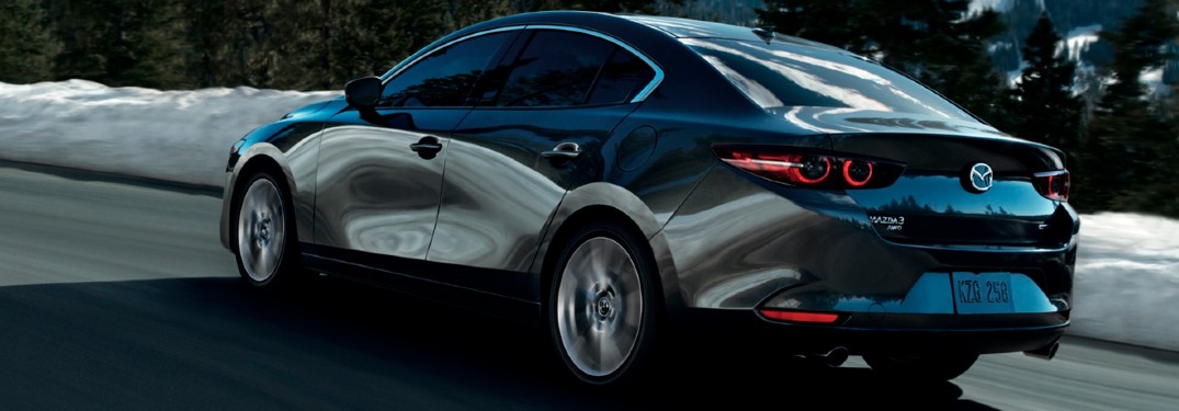 The side and rear view of a gray 2021 Mazda3 Sedan.