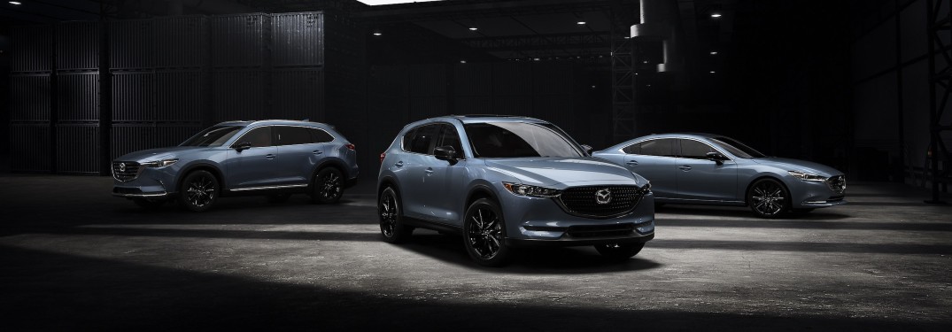 Three gray 2021 Mazda Carbon Edition models parked in an enclosed space.