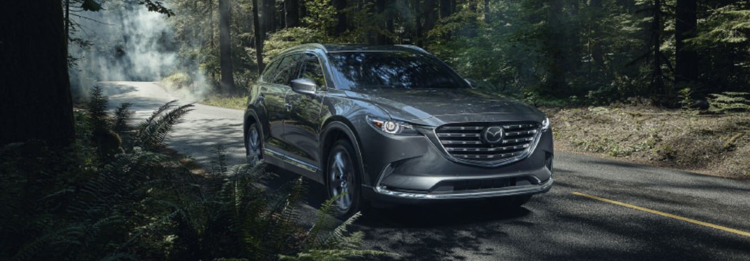 The front and side view of a gray 2021 Mazda CX-9.
