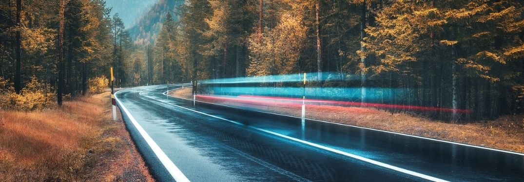 Fall road with a blurred vehicle