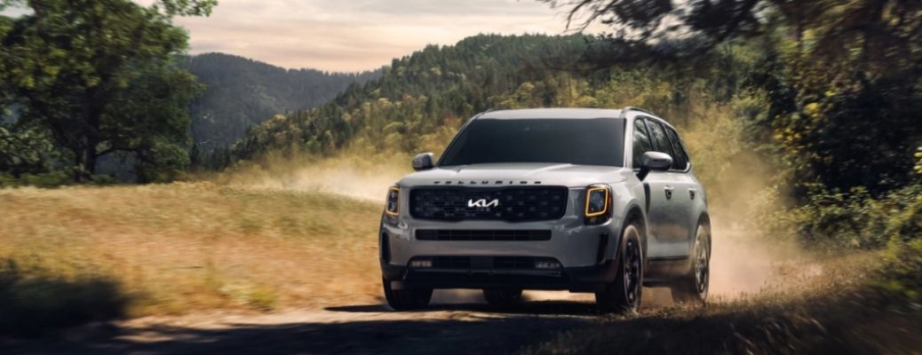 Front view of a gray 2022 Kia Telluride cruising through a field. What are the engine specifications?