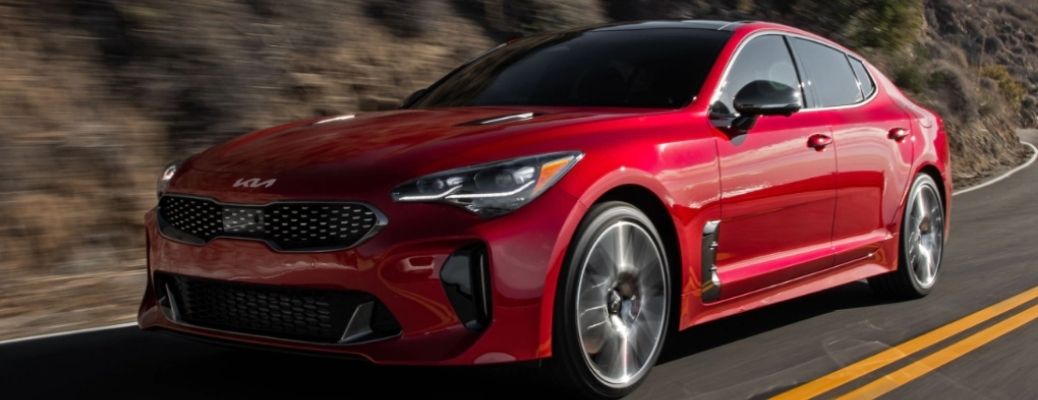 Red 2022 Kia Stinger cruising on a road