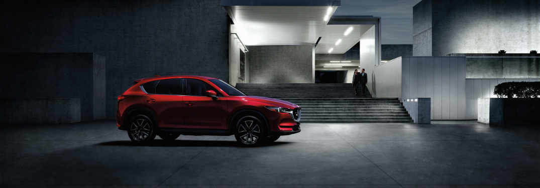 red 2018 mazda cx-5 in front of concrete modern home