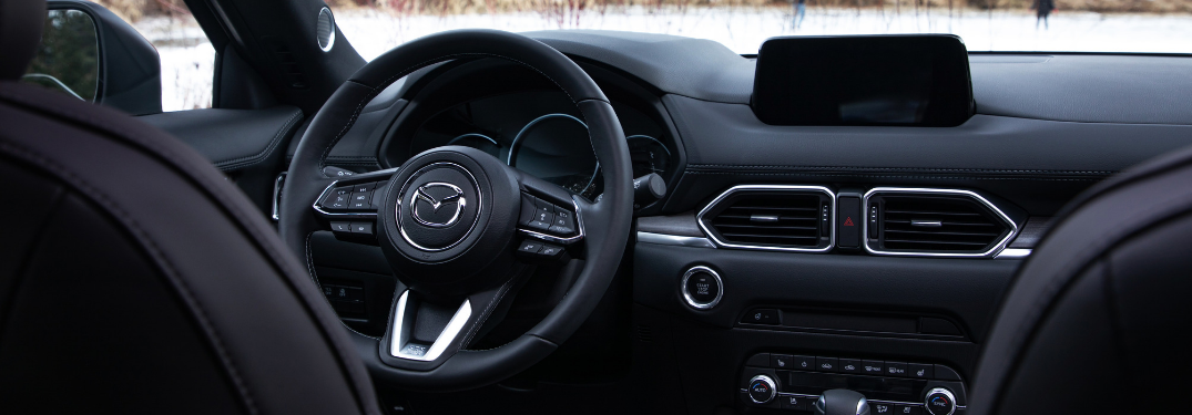 front interior of 2019 mazda cx-5 including steering wheel and infotainment system