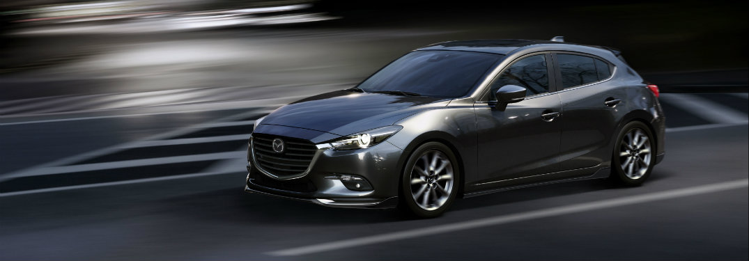 dark gray mazda3 driving at night