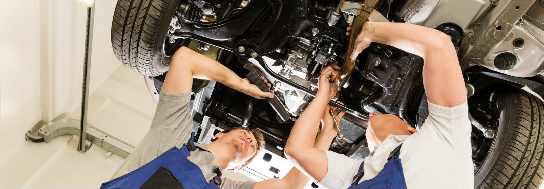 two men working under car