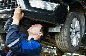 man working under car