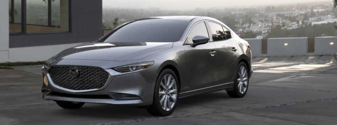 silver mazda3 sedan side front view