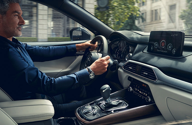 The interior view of a man driving a 2020 Mazda CX-9.