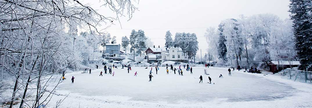 wide angle shot of people on an outdoor ice skating rink