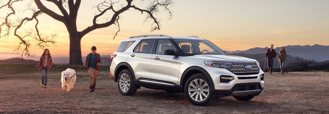 2020 Ford Explorer Hybrid on field with family