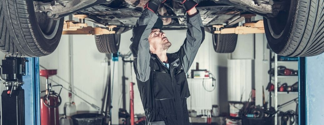 Mechanic changing engine oil.