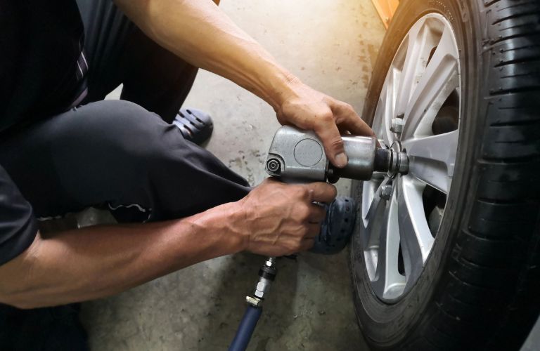 A man aligning a car's wheel