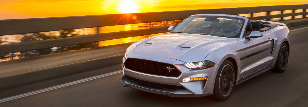 2019 Ford Mustang California Special exterior front driver side view with the coast and sunset behind it