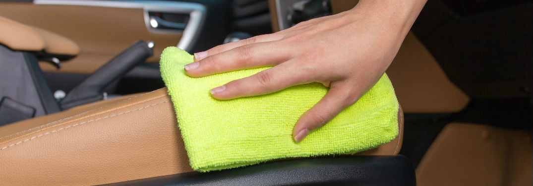 woman's hand wiping down leather seats