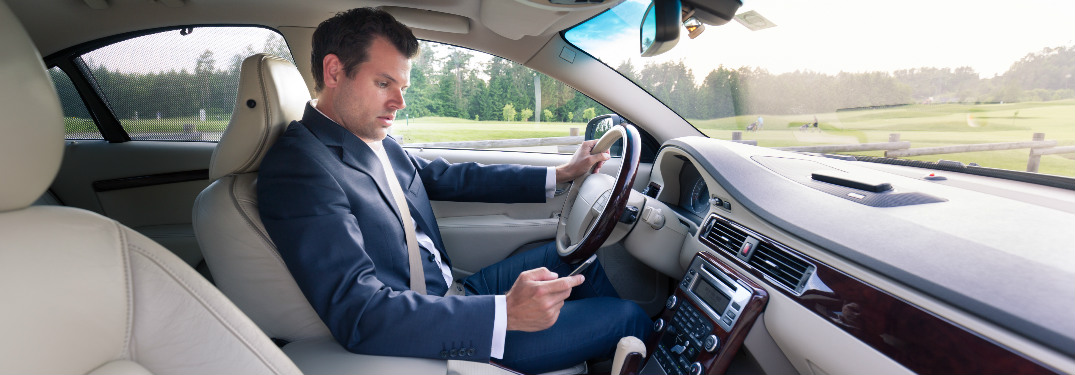 man texting on phone while driving