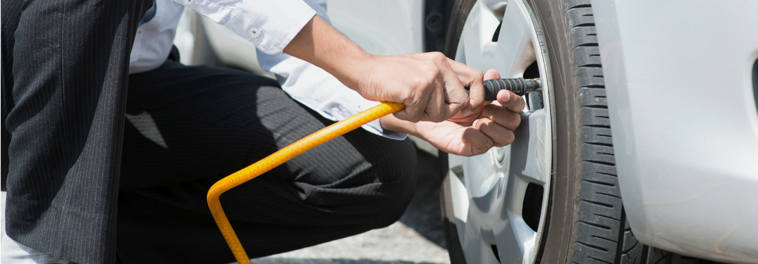 man putting air into tire