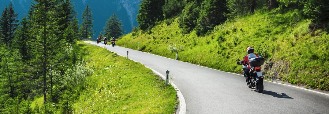 motorcyclists going through mountains