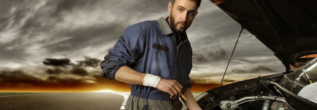 Man changing the oil on a car