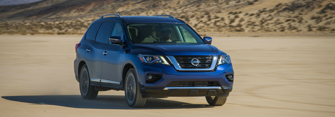 blue 2018 nissan pathfinder driving through desert
