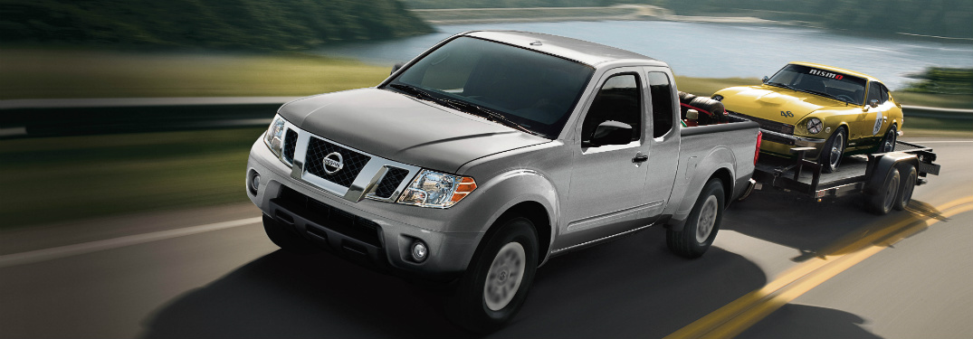 silver 2018 nissan frontier towing classic car on trailer