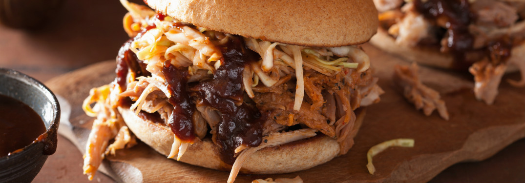 bbq pulled pork sandwich with coleslaw sandwich on wooden board
