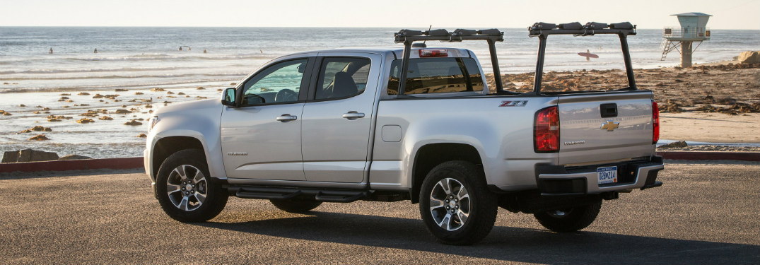 rear and side view of silver 2018 chevy colorado looking towards ocean