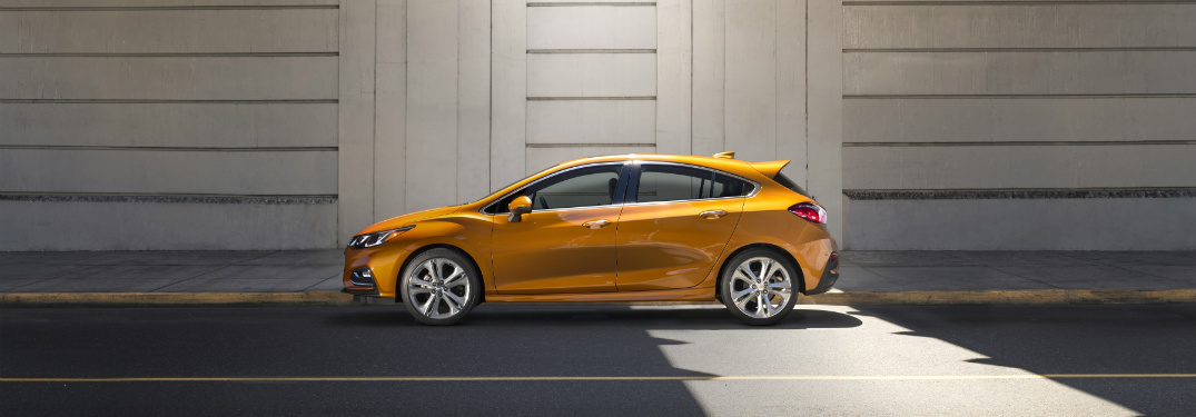 side view of orange parked underneath bridge