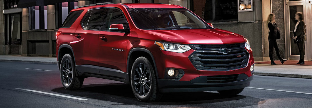 front and side view of red 2019 chevrolet traverse driving on city street