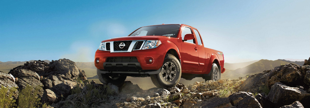 front and side view of red 2018 nissan frontier on rocky cliff