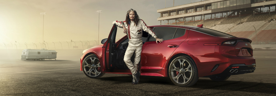 steven tyler in front of 2018 kia stinger on race track for super bowl commercial